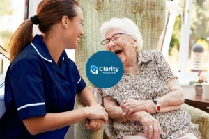 a care worker with an old women looking and smiling at each other